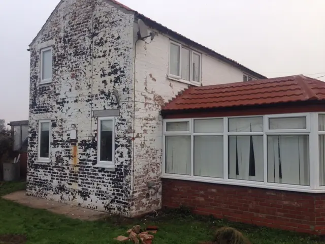 Patchy weathered wall before