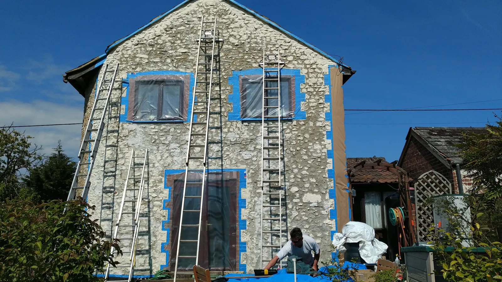 House masked and prepared for coating